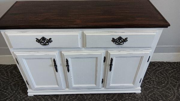 Two-tone wooden cabinet with a dark stained top and a white painted body with two drawers and three paneled doors