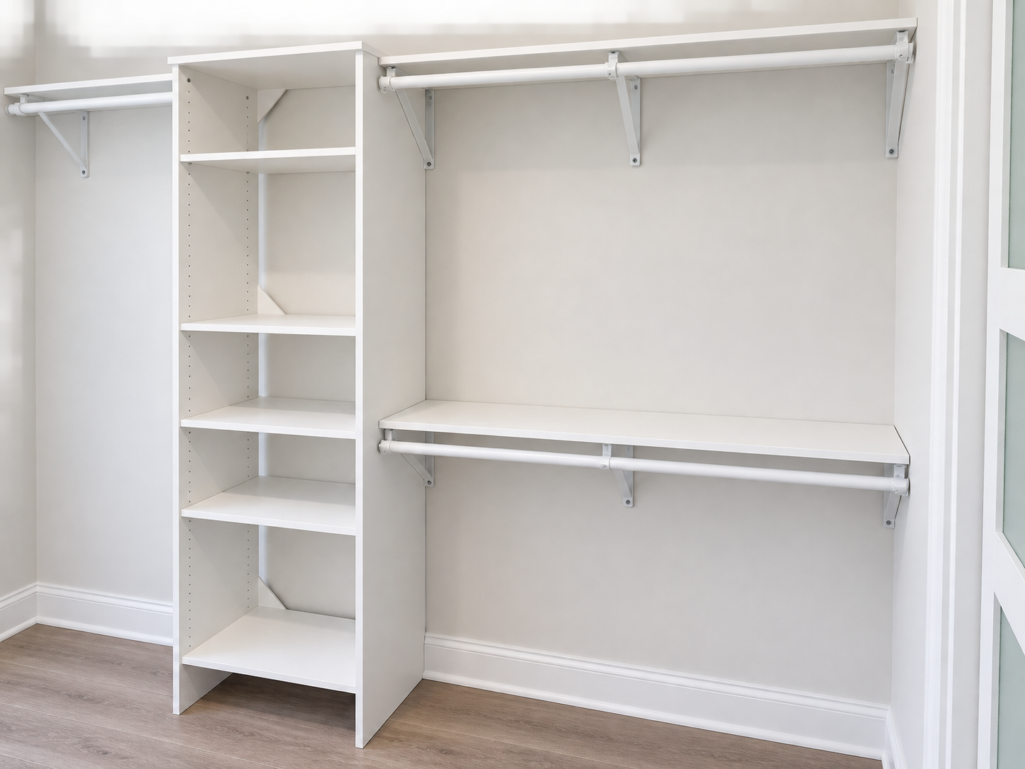 White built-in closet with a tall shelving tower and two hanging rods on a light gray wall